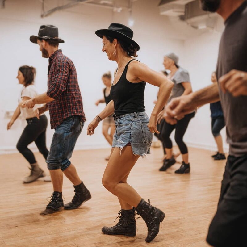 Line dancing hen party Bristol - women in cowboy hats doing a line dance